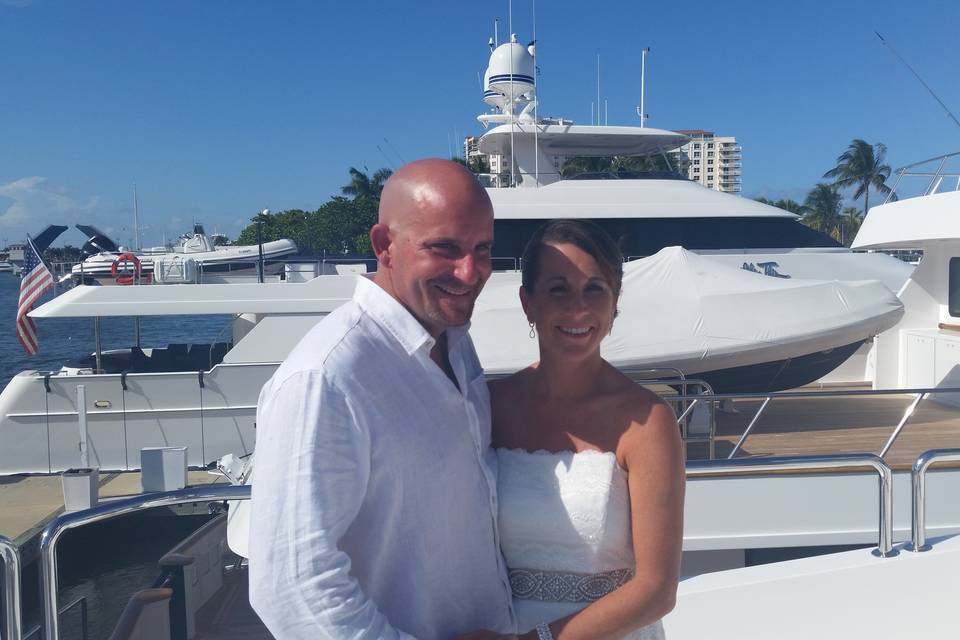Newlyweds by the yacht