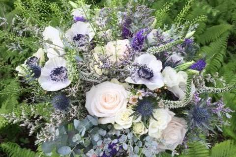 White roses and lavenders on bridal bouquet