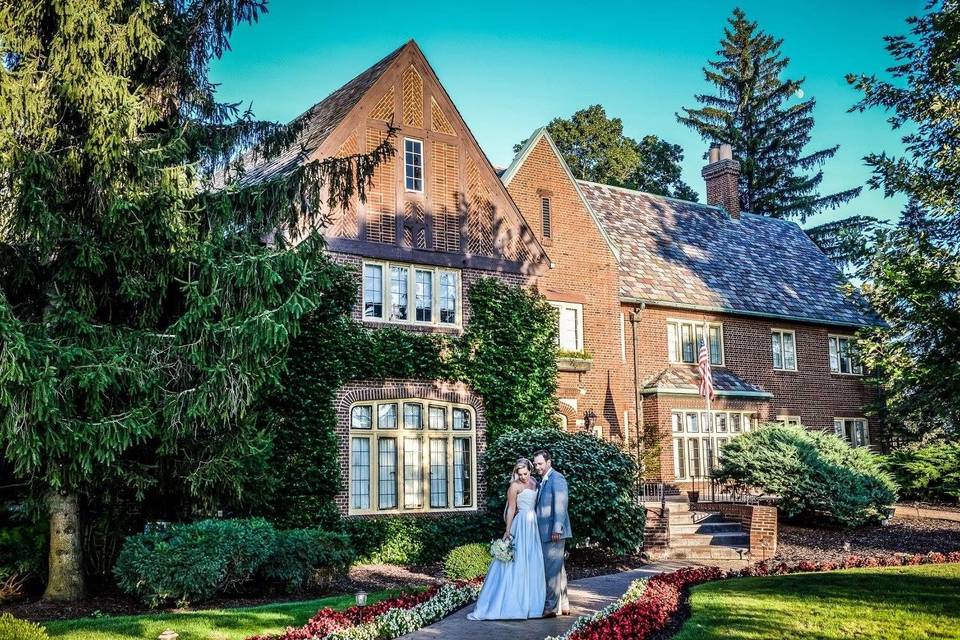 Bride and groom front of inn