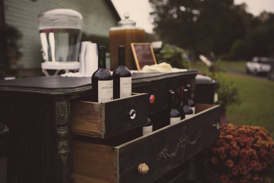 Vintage dresser that servers as a drink station for this backyard wedding & reception.