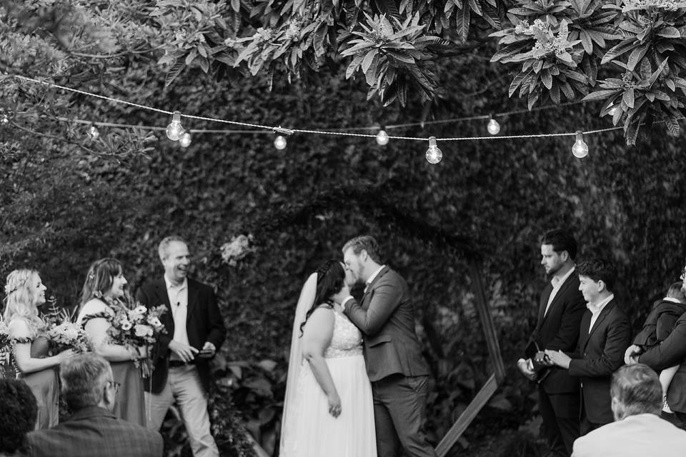 Newlyweds kissing at ceremony