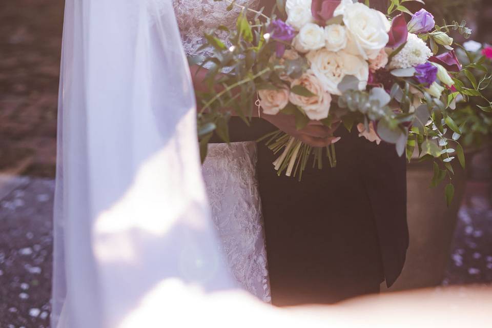 Newlyweds kissing in garden