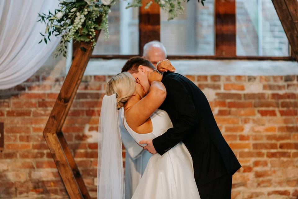 Newlyweds kissing ceremony