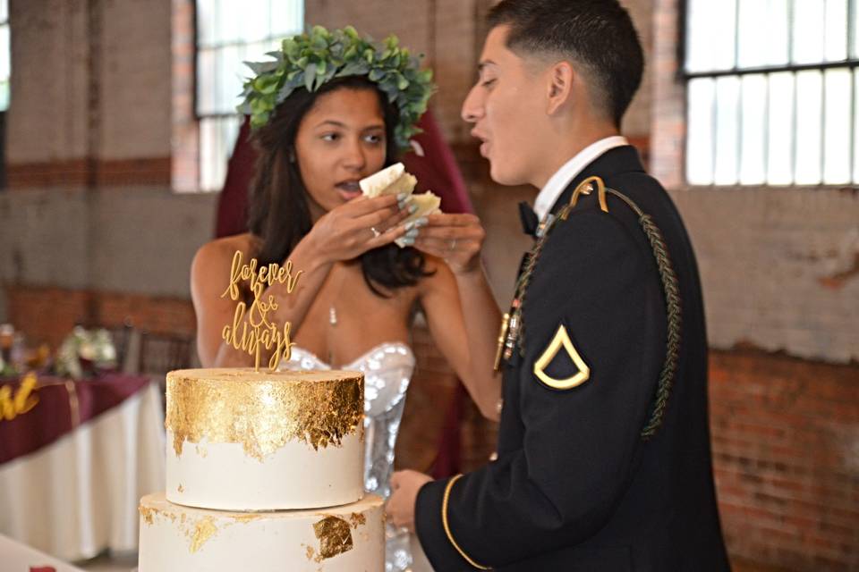 Bride feeds cake to groom