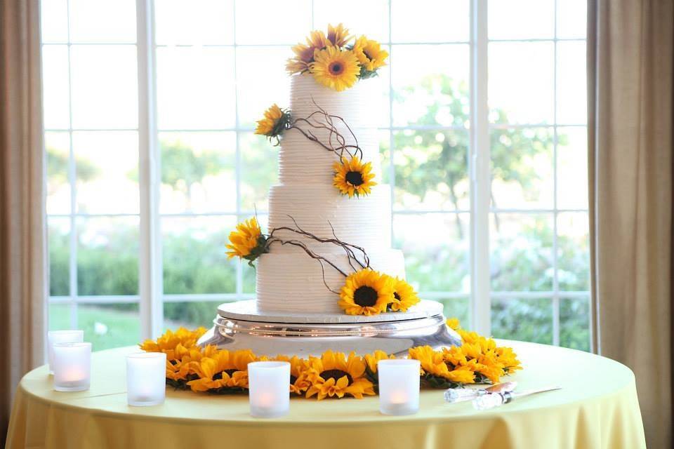White wedding cake with sunflower decorations