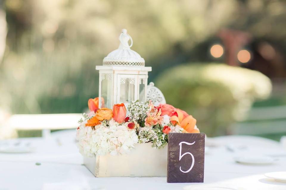 White table centerpiece with a touch of orange