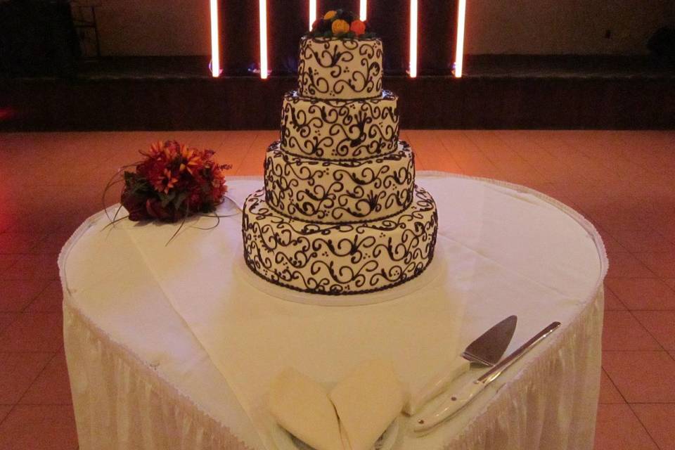 Black and white design cake on a white heart shaped table