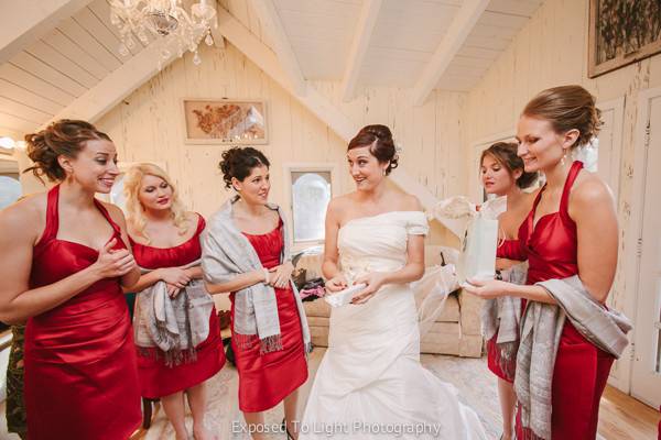 Bride with bridesmaids prior to wedding ceremony at Woods Chapel in Orono Minnesota.