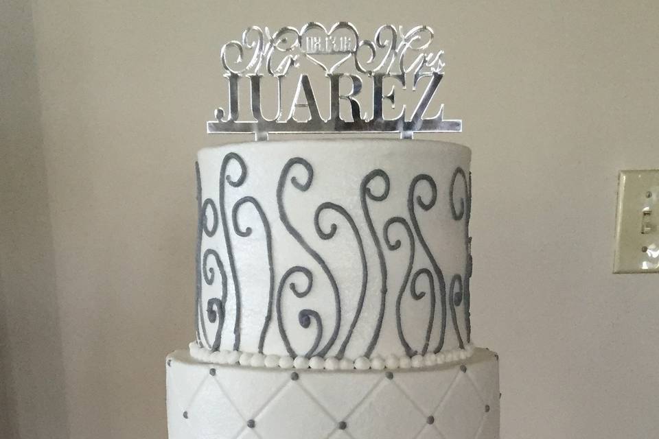 An elegant gray and white buttercream cake with a stunning brush embroidery tier!