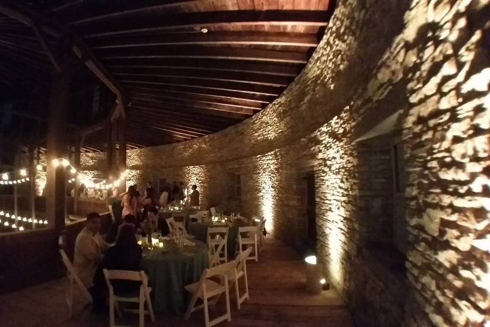 Uplighting and string lighting in the upper level of the historic Round Stone Barn at Hancock Shaker Village.