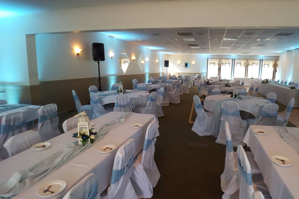 Uplighting and a massive twinkling fabric back drop behind a 12 person head table at the Skyline Country Club in Lanesborough , Mass.