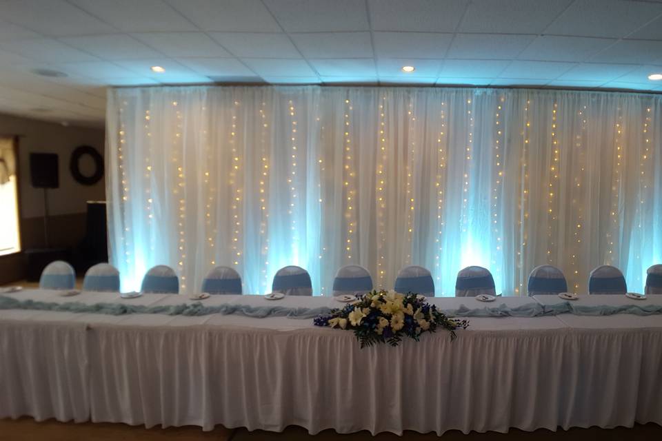 A massive twinkling fabric back drop behind a 12 person head table at the Skyline Country Club in Lanesborough , Mass.