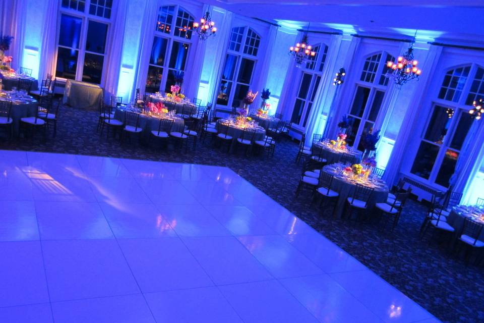 Royal blue uplighting and pin spotting on the dining tables at Cranwell Resort in Lenox, Mass.