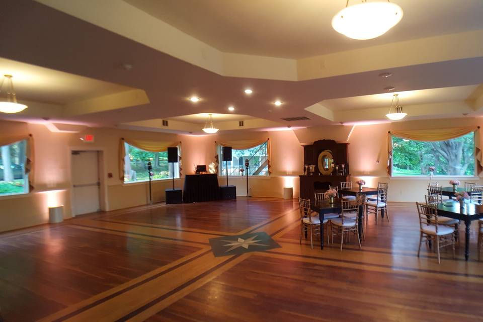 Blush pink uplighting in the music room of the Seven Hills Inn in Lenox, Mass.