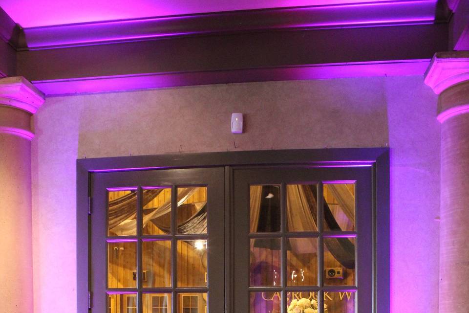 Pink up-lighting added a flair to make a grand entrance from the band with dance floor in the Tasting Room into the reception in the Barrel Room through the double glass doors.