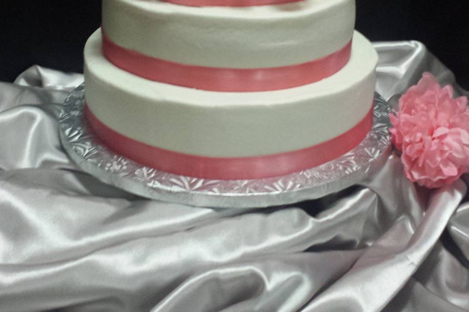 Buttercream with satin ribbon and flowers