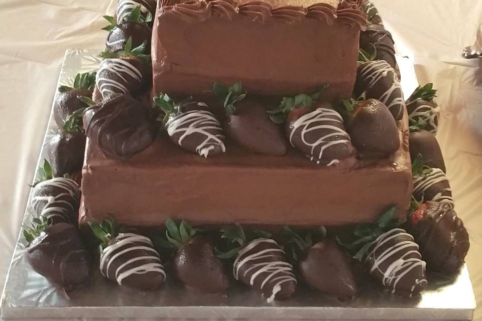 Chocolate cake with raspberry filling and chocolate buttercream icing.  Chocolate covered strawberries