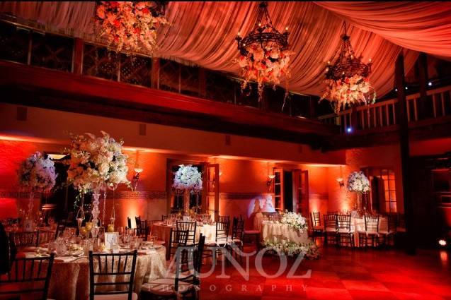 This event featured tables dressed in floor length White Poly Linen accented by French Sheer Champagne Overlays.