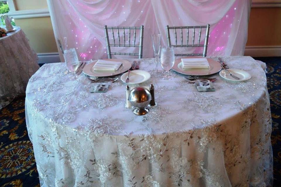 This event featured White Poly Linens accented by White and Silver Vintage Overlays.