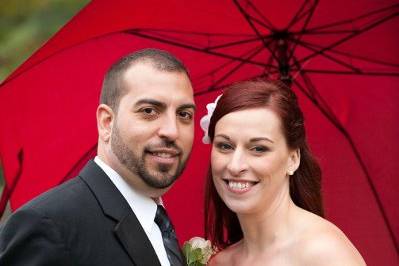 Newlyweds sharing an umbrella