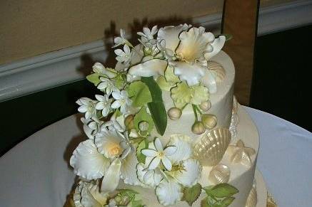 Tropical Ocean Cake. Buttercream covered yellow cake decorated with sugar orchids and hibiscus.