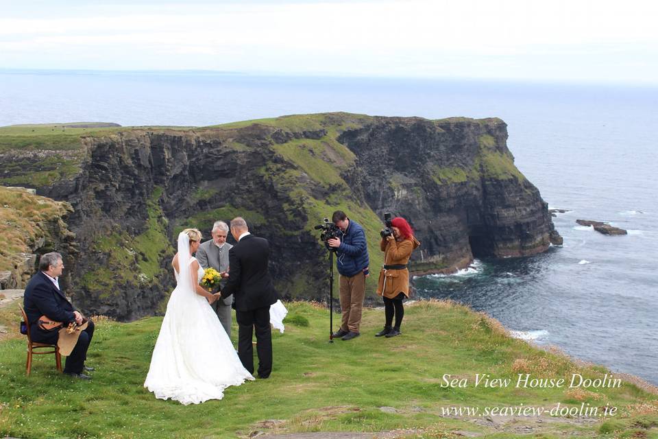 Hags Head is a  stunning remote edge of the world cliff top location. Towering 600 ft above the waves and featuring  dramatic cliffs views its a dreamy one of a kind wedding location.