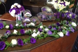 Purple and white garlands, centerpieces and bouquets.
Calla lilies and lisianthus flowers