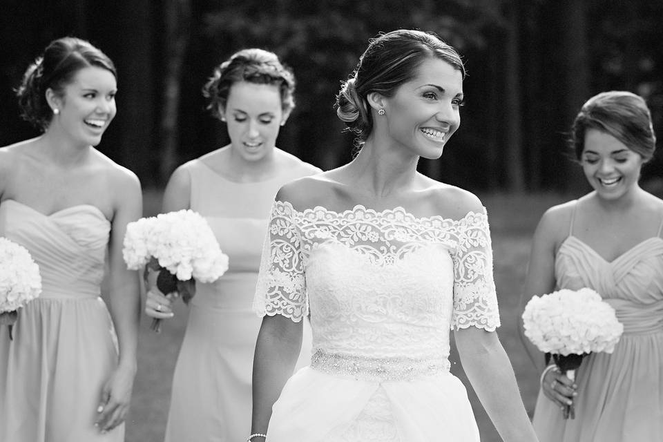 A stunning black in white wedding image of Alex with her bridesmaids, captured at the Barn at Rock Creek by Raleigh wedding photographer Erin Costa Photography.