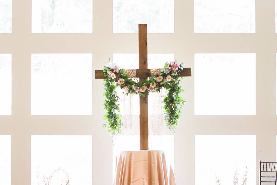 Cross draped in flowers