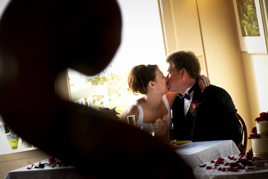 A candid romantic moment during the reception at the Albion River Inn, on the Mendocino Coast of California.