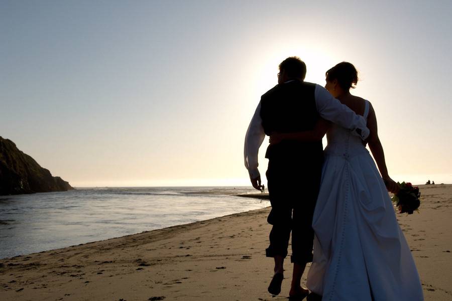 A romantic walk on the beach concludes a long and wonderful wedding day in Mendocino, California.