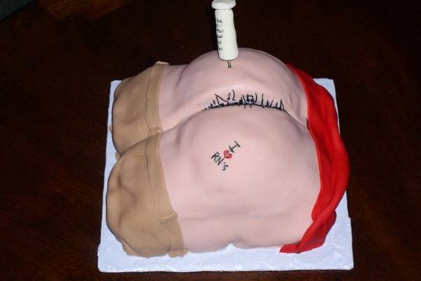 Spice cake with cream cheese frosting covered in fondant with white chocolate syringe
