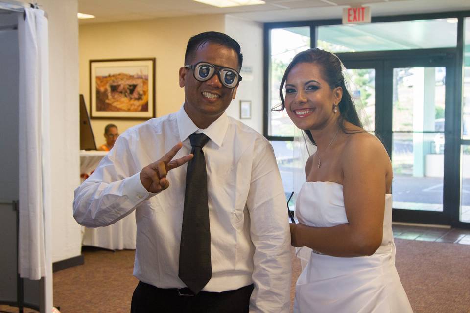 The emcee and bride testing out the Photo Booth props.