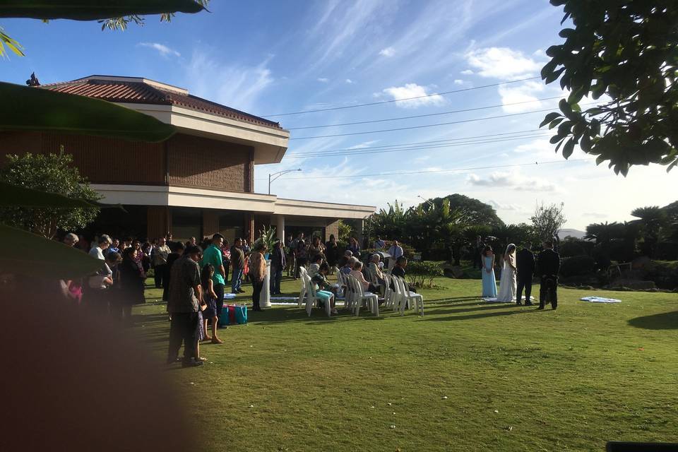 Okinawan Center, their venue, allows for a ceremony on the lawn besides the hall. Guests can watch the ceremony and head indoors for cocktail hour afterwards. The lawn features an outdoor waterfall and fish pond.
