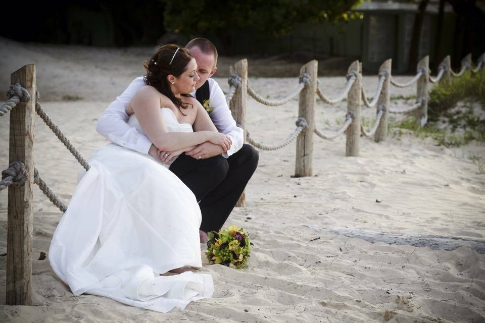 Groom embraces his bride