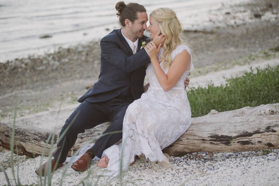Bride and groom on rocky beach