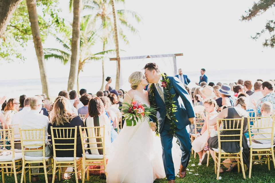Bride and groom aisle kiss