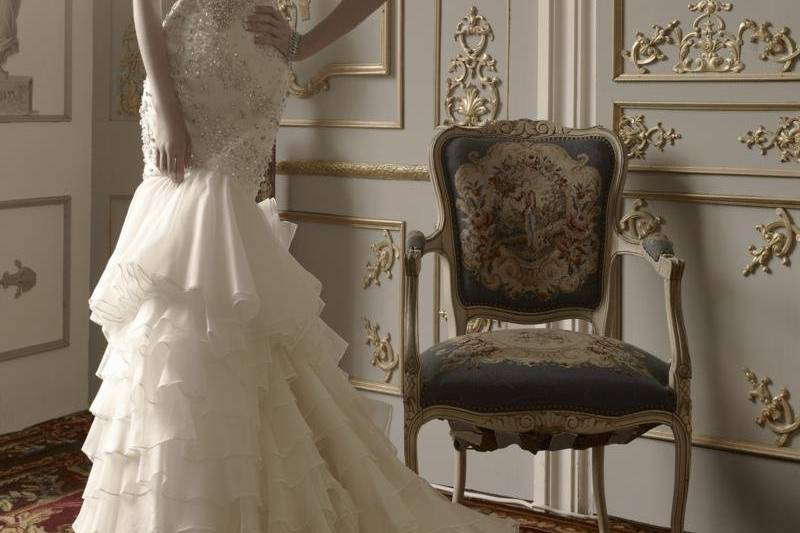 Gown features crystal-and-pearl beaded bodice, embroidery and ruffled tiered skirt.