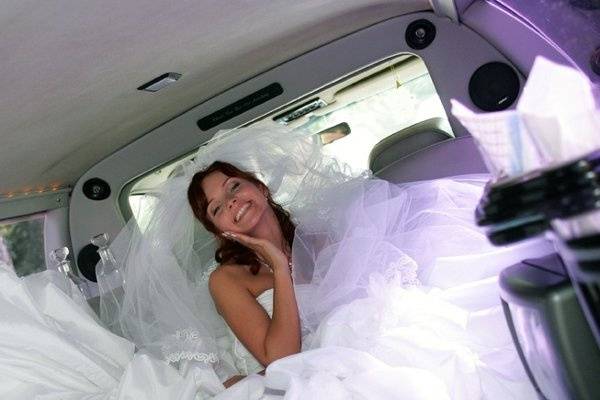 Happy bride in SUV limo