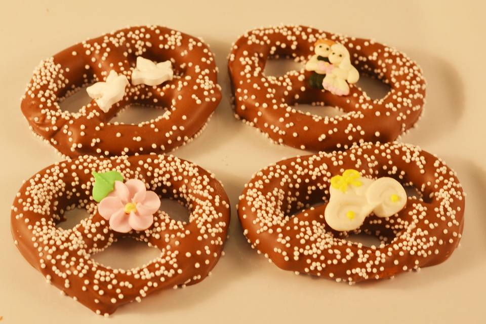 A single pretzel coated in our creamy and delicious Swiss chocolate is sure to please. Choose a candy for the center as shown -- bride & groom, white doves, single flower, or calla lilies. Elegant -- yet affordable!. Comes wrapped in cello. We will add a tag with your names and date if you choose.
