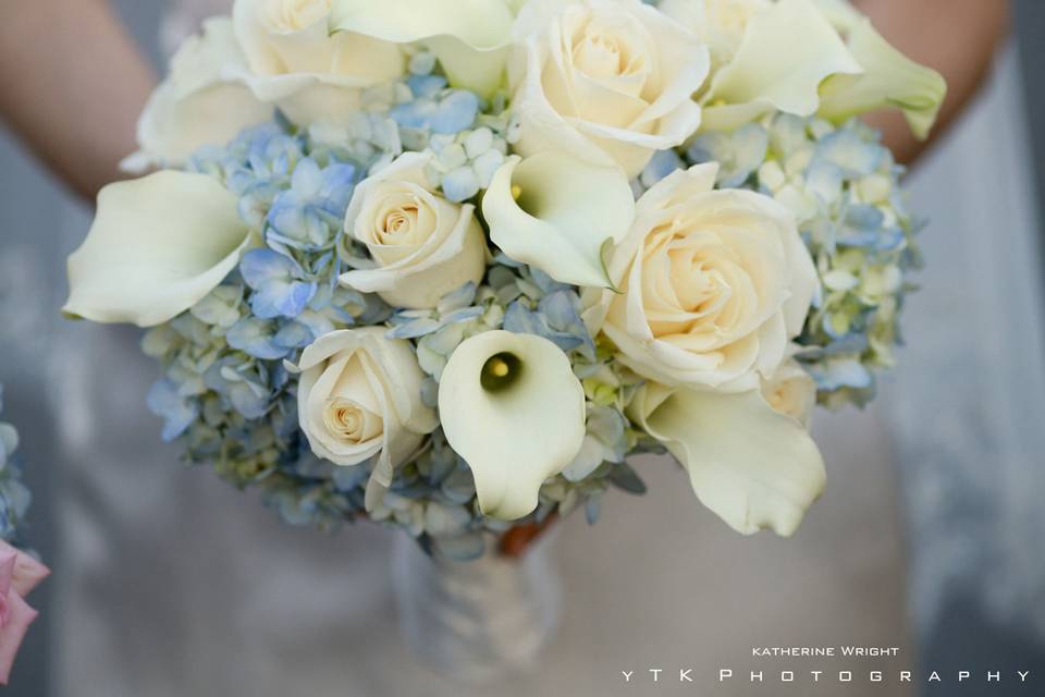 Fresh white wedding bouquet with soft blue flowers