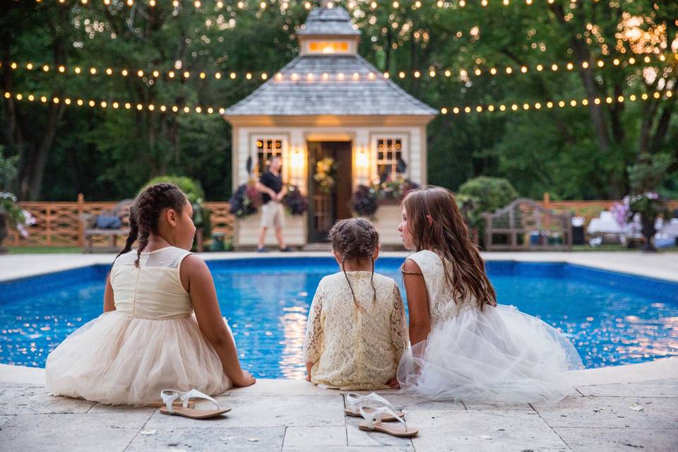 The girls sitting by the pool.