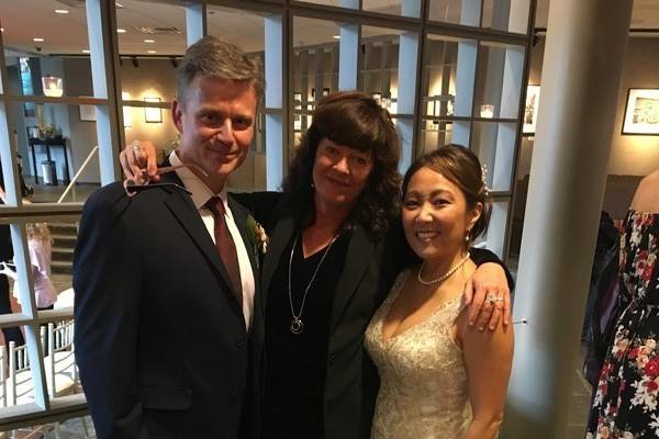 Joyful couple with officiant