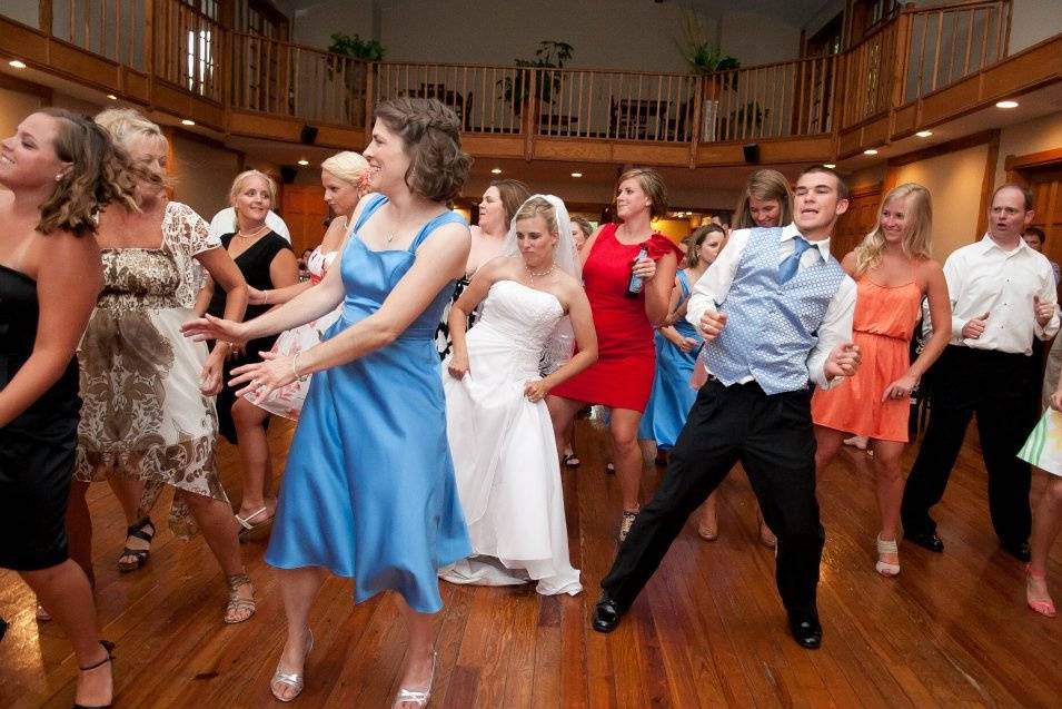 Newlyweds and their guests dancing