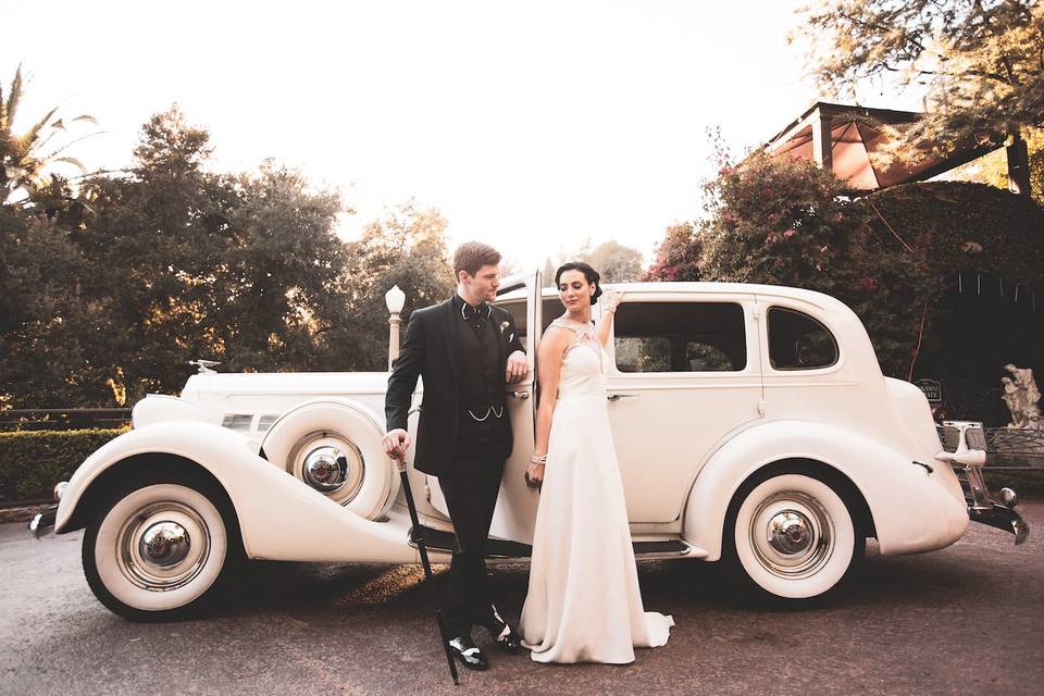 Couple with wedding car
