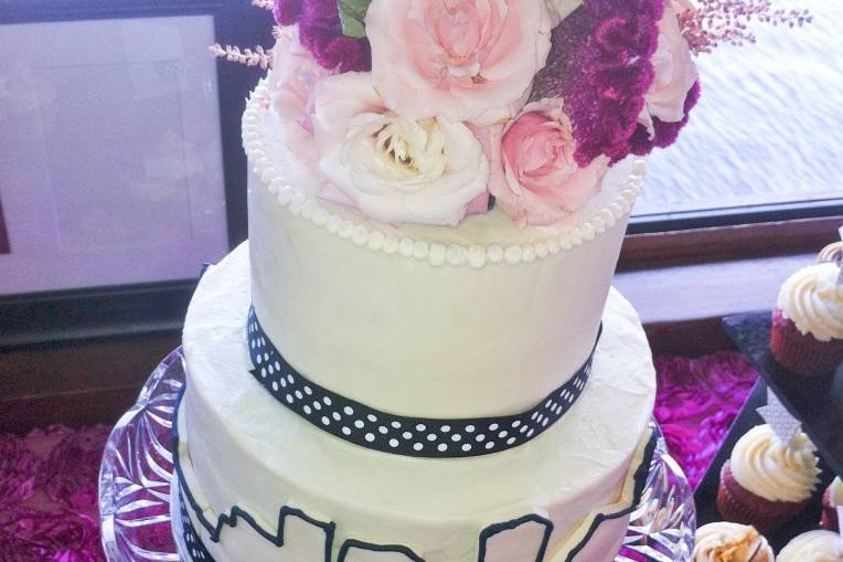 White wedding cake topped with flowers