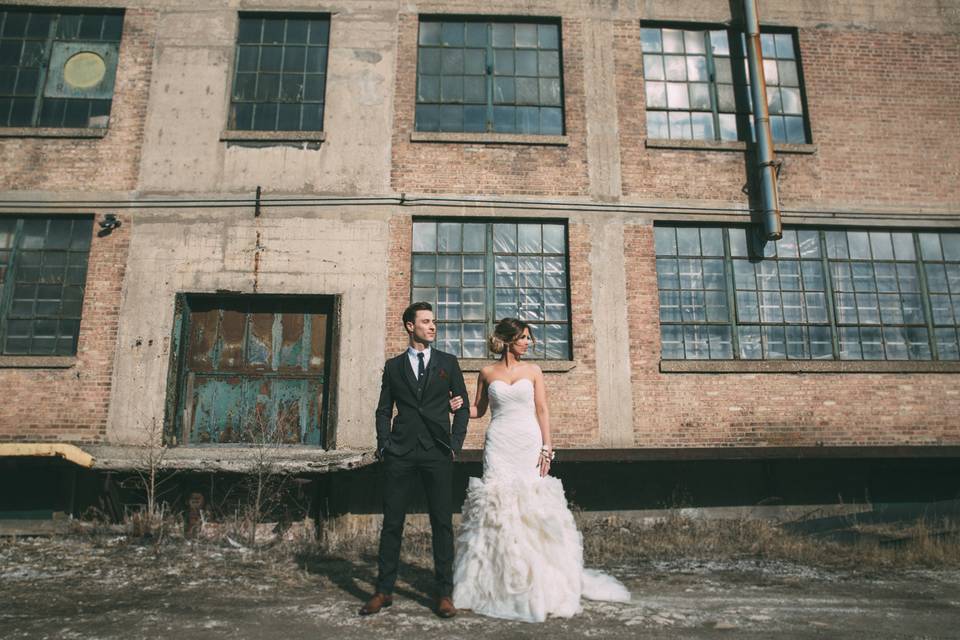 Dramatic pose in front of industrial building