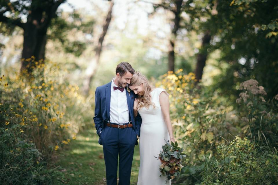 Couple pose on path in woods