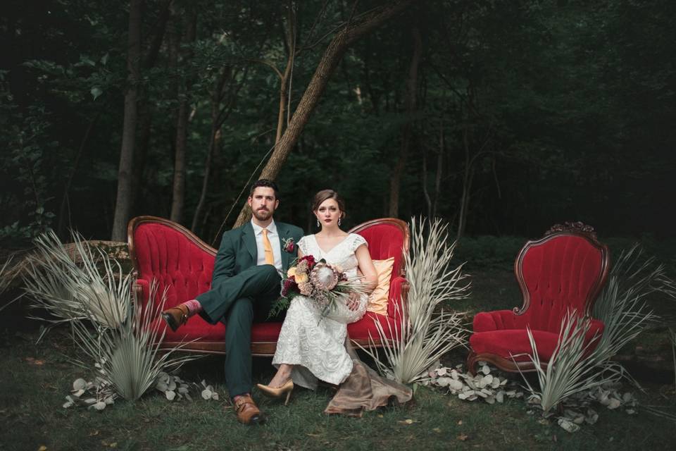 Dramatic wedding portrait on red couches