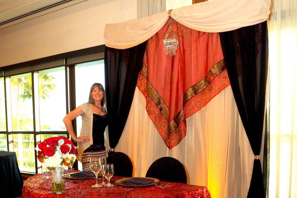 Indian inspired red, gold, and black backdrop with red sequin linen